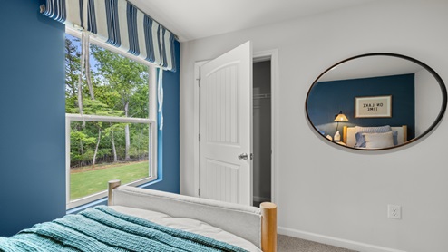 Bedroom with neutral carpet , a single window, and a closet.