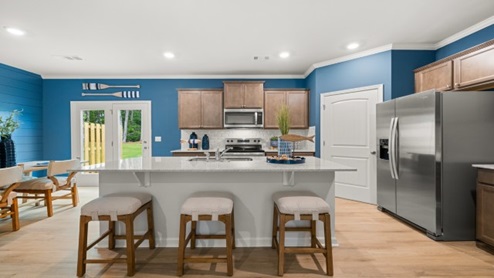 Interior kitchen with center island and light brown cabinets