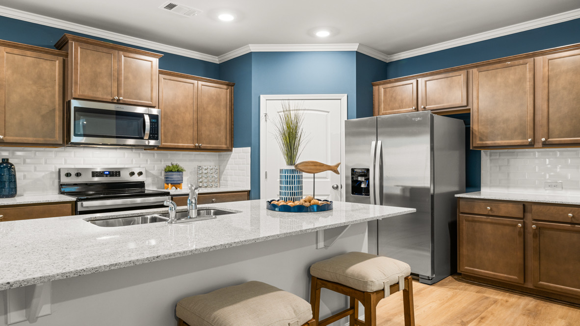 Interior kitchen with center island and wooden cabinets