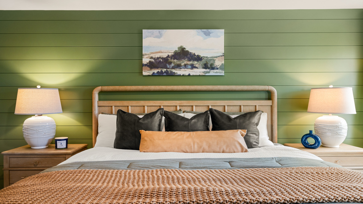 Interior primary bedroom with large windows