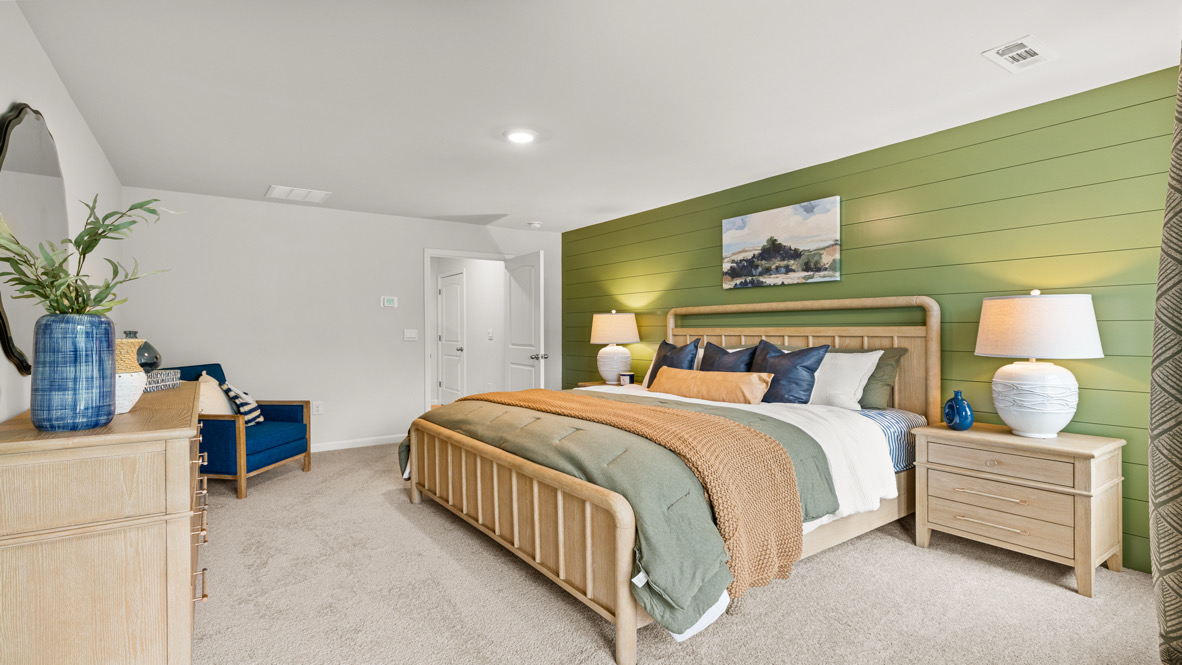 Interior primary bedroom with large windows