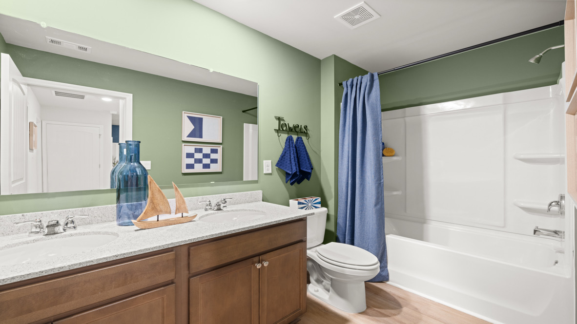 Interior bathroom with double sink and full-sized shower