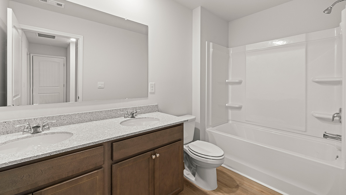 Interior bathroom with double sink and full-sized shower