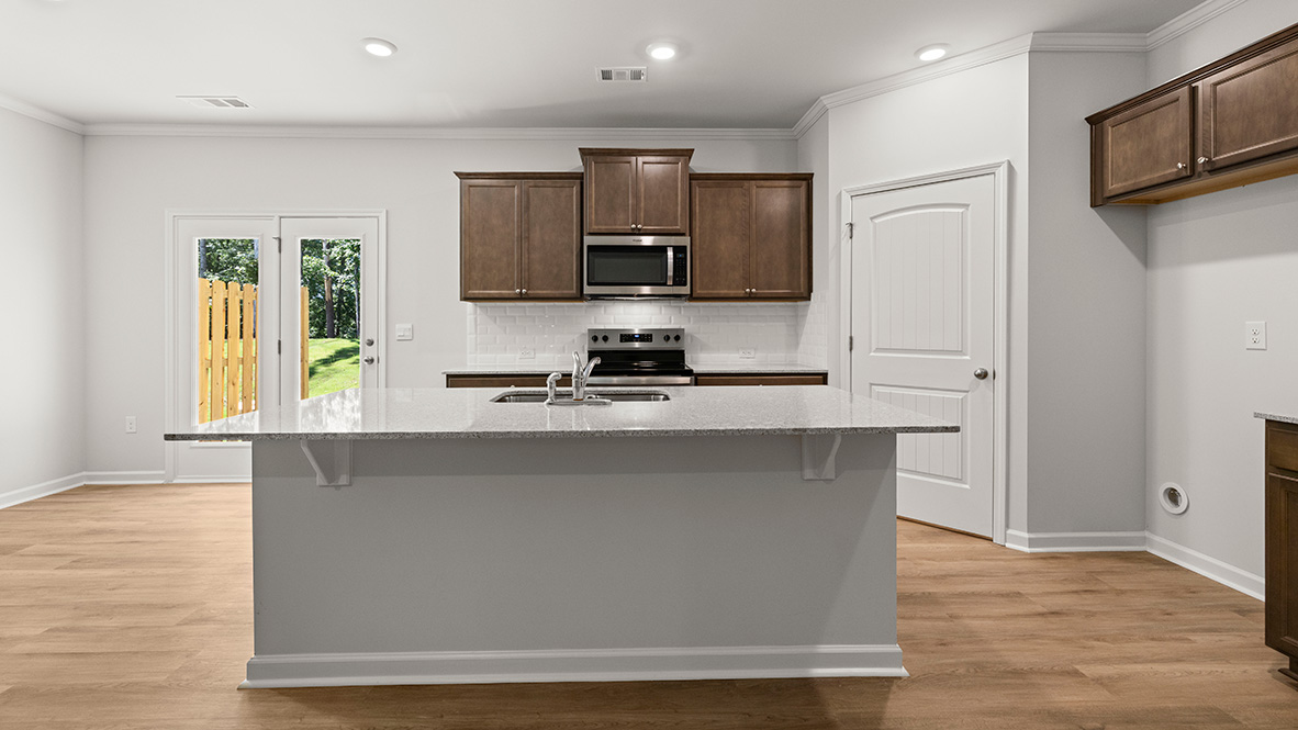 Interior kitchen with center island and wooden cabinets