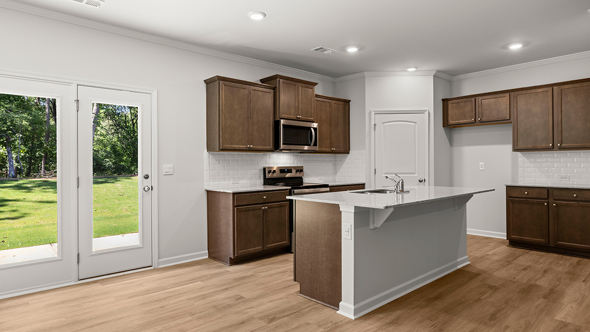 Interior kitchen with center island and wooden cabinets