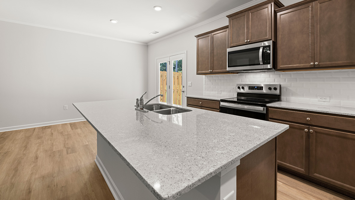 Interior kitchen with center island and wooden cabinets