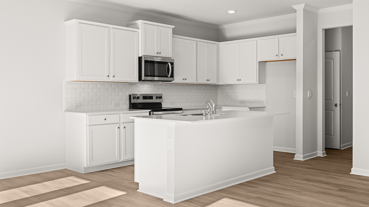 Interior kitchen with center island and white cabinets