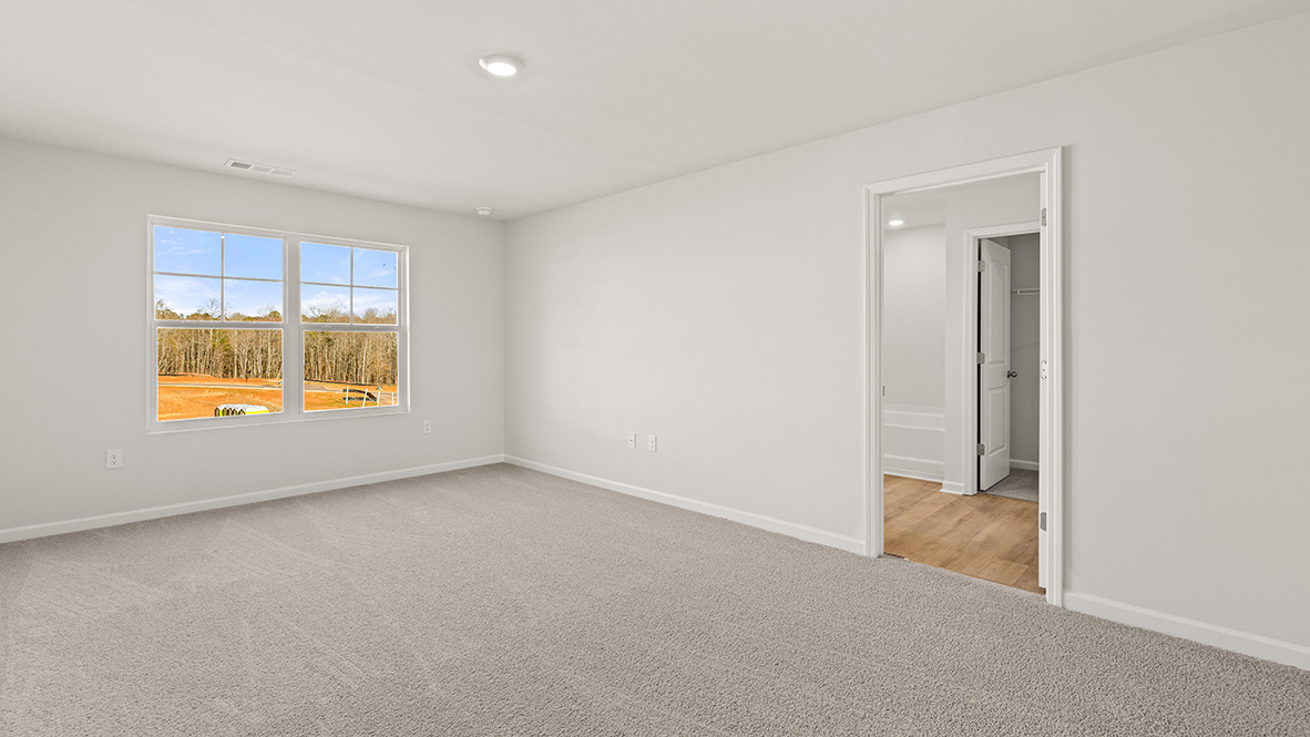 Interior primary bedroom with large window