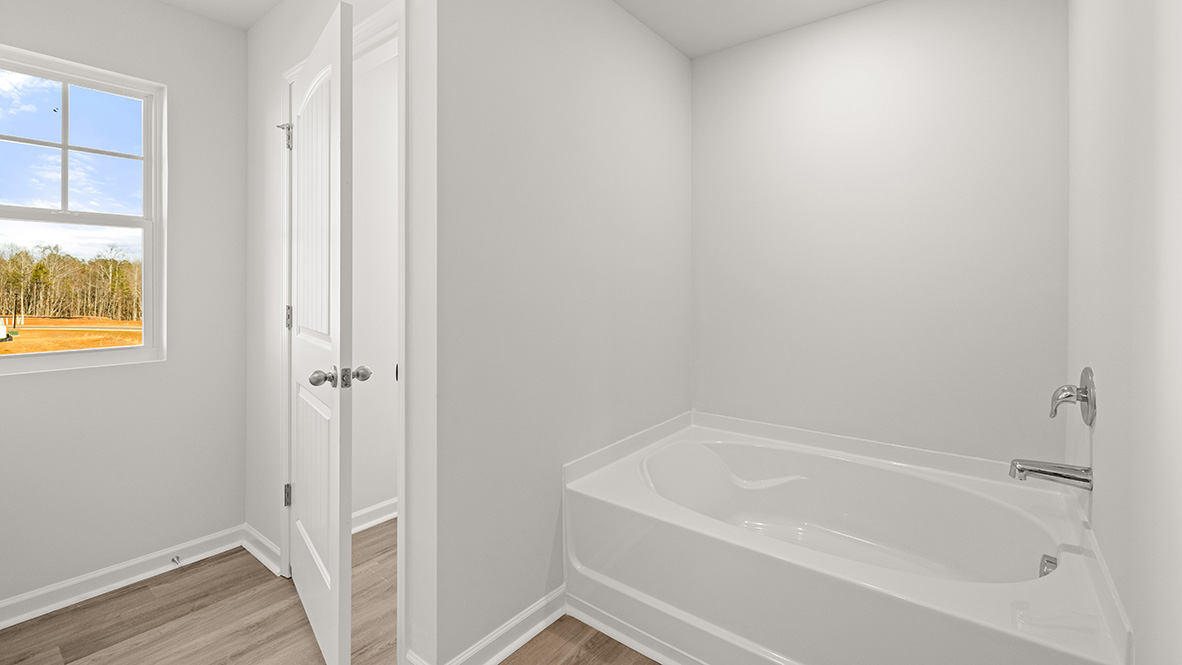 Interior primary bathroom with bath tub