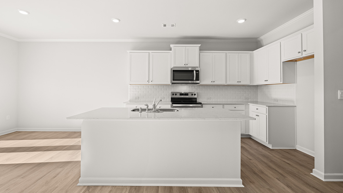 Interior kitchen with center island and white cabinets