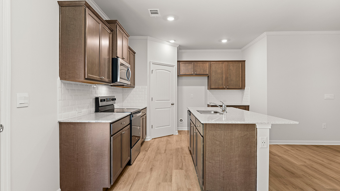 Interior kitchen with center island and wooden cabinets