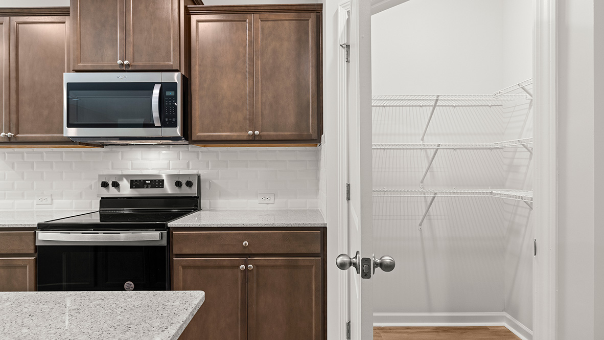 Interior kitchen with center island and wooden cabinets