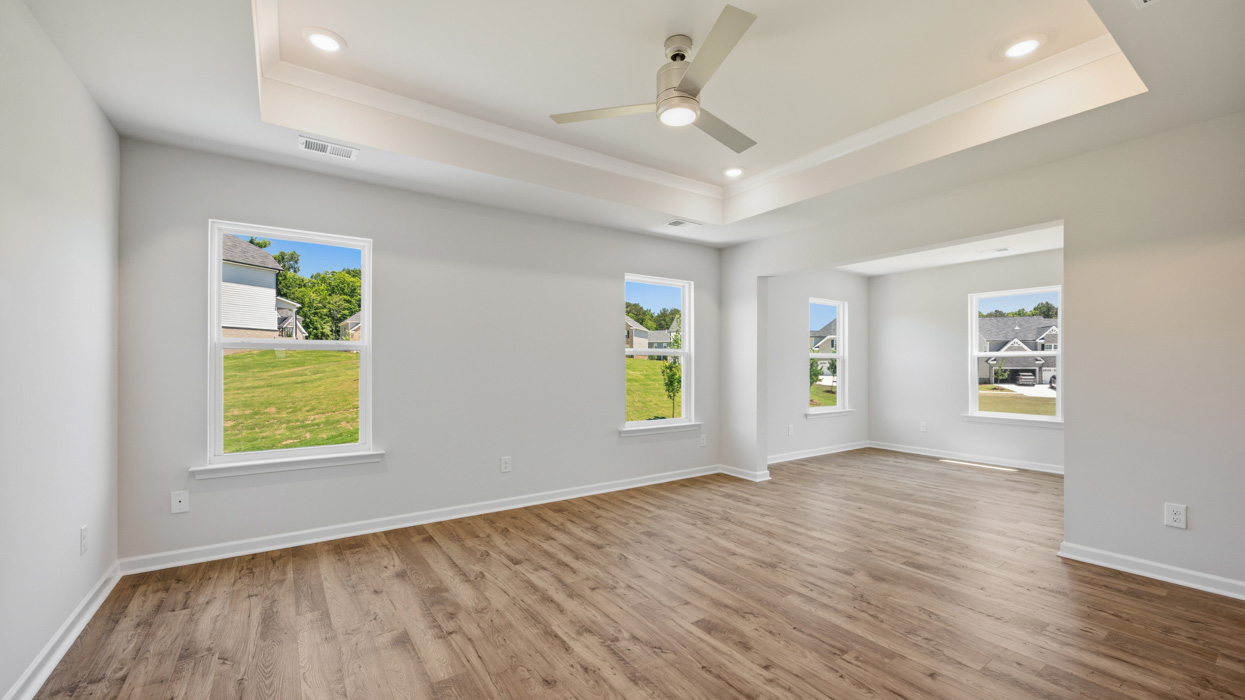 primary bedroom and sitting room with abundance of natural light