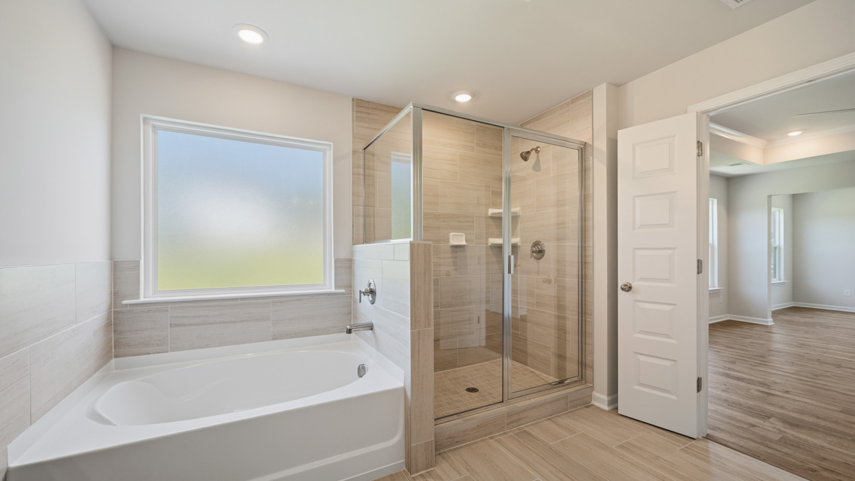 primary bathroom with walk-in shower and tub