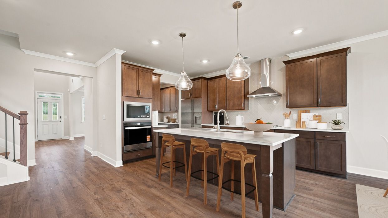 angled kitchen with spacious burlap cabinetry with large center island