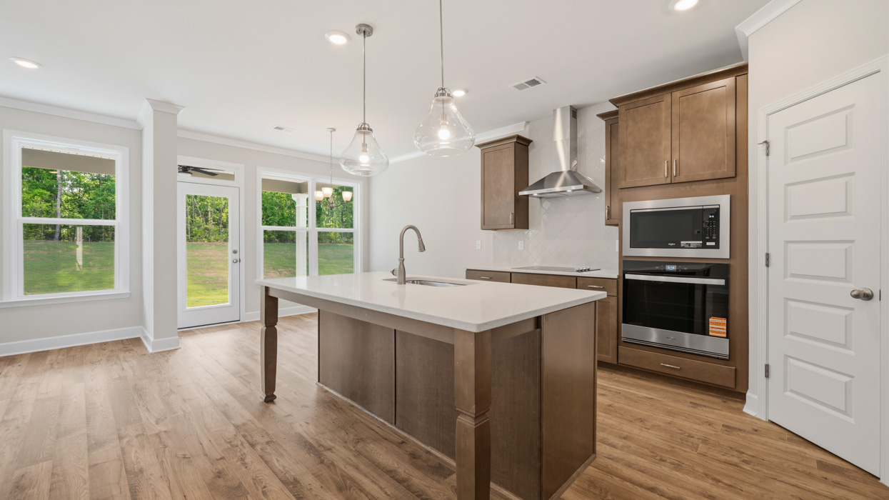 angled kitchen with large center island and spacious burlap cabinetry