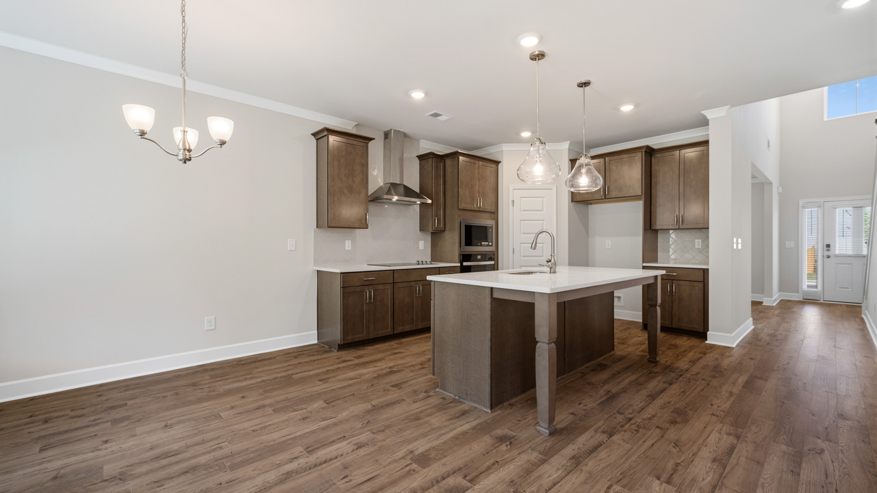 angled kitchen with large center island and spacious burlap cabinetry
