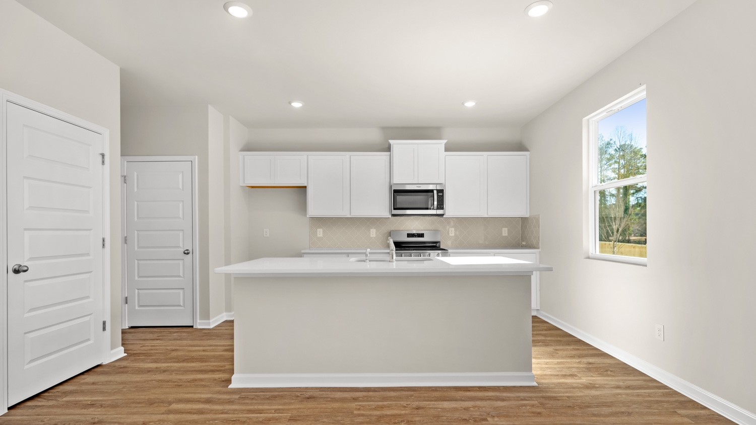 kitchen with center island and spacious white cabinets