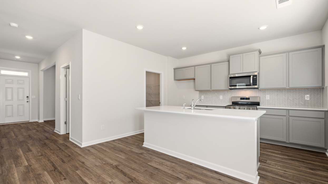 angled kitchen with spacious white cabinets and center island