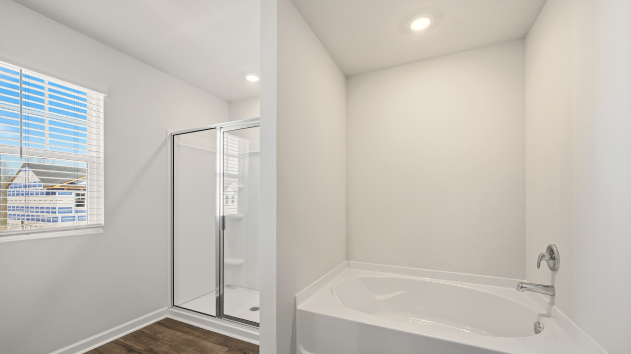 primary bathroom with stand-up shower and bathtub