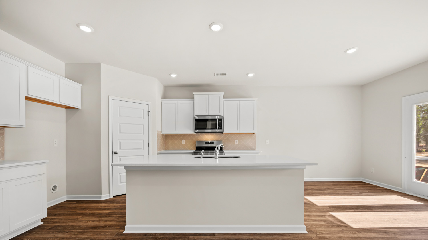 kitchen with large center island and spacious white cabinets