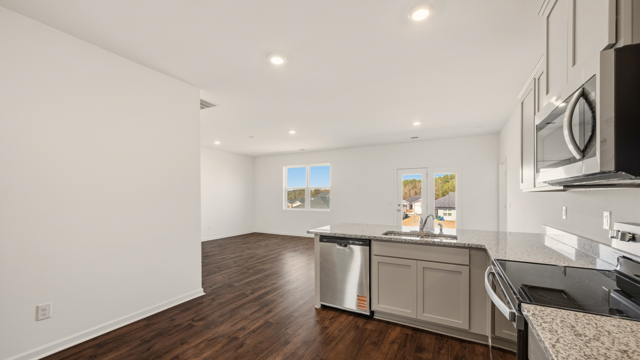 livng room from kitchen with access to patio