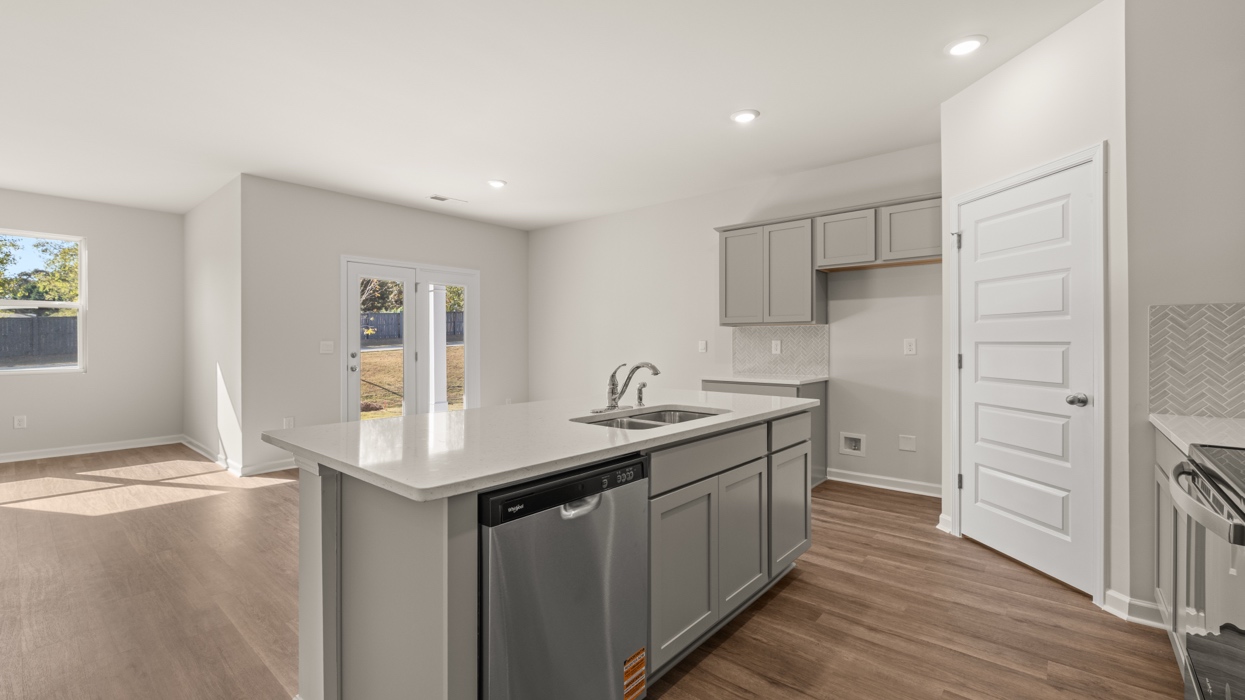 angled kitchen with spacious gray cabinets