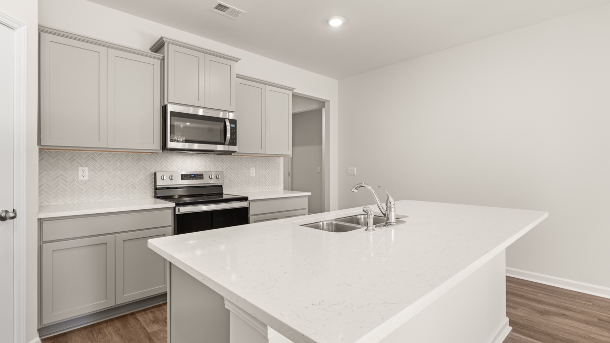 kitchen with spacous gray cabinets and a large center island