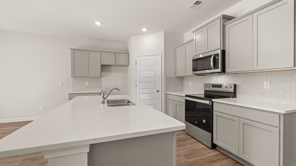 kitchen with spacous gray cabinets and a large center island