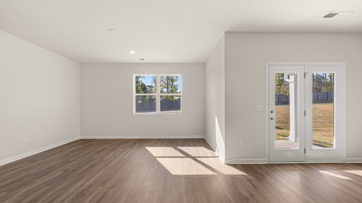 living room with natural light and dining room with access to patio