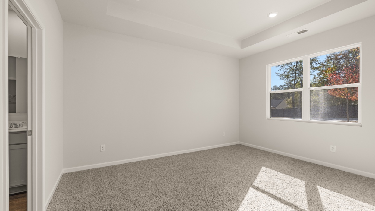 angled primary bedroom with natural light