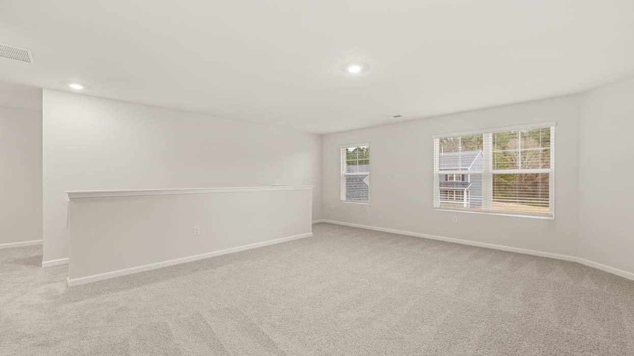 angled upstairs loft with abundance of natural light