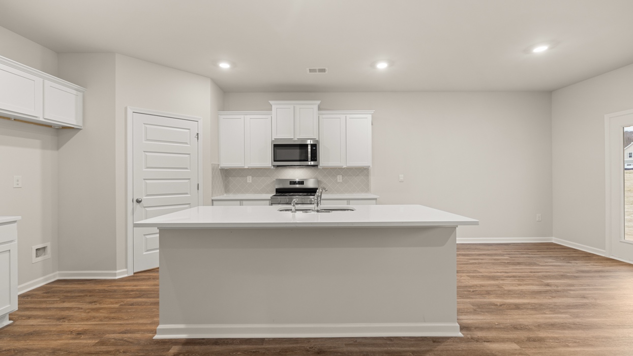 kitchen with spacious white cabinets and large center island