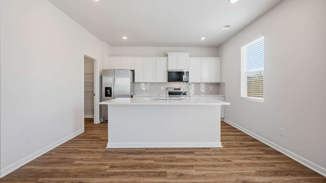 kitchen with large center island and spacious white cabinets