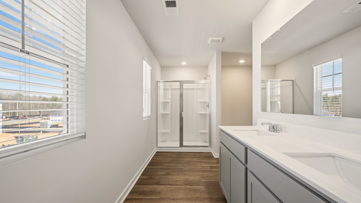 primary bathroom with natural light and dual sinks