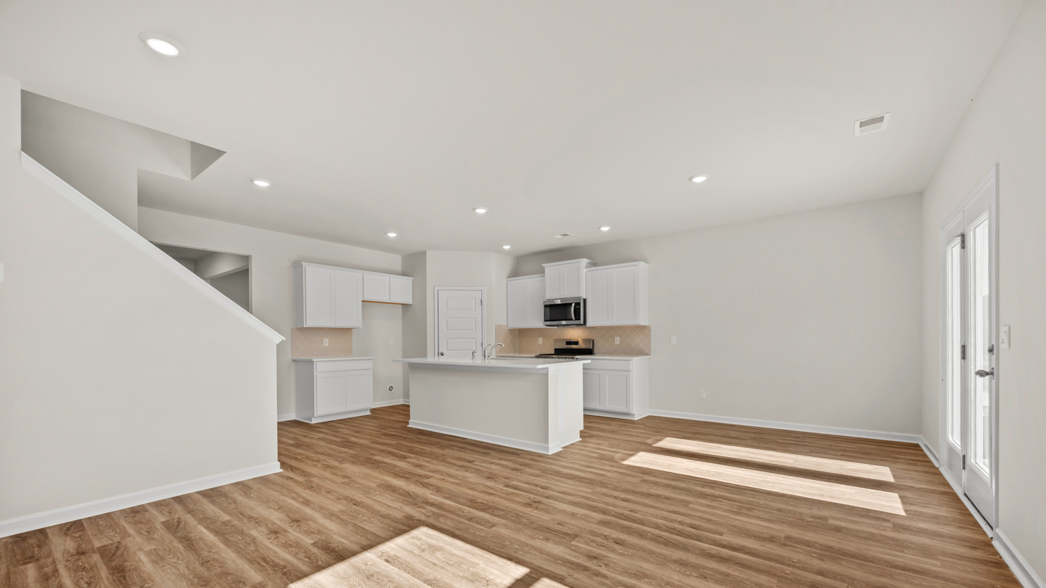 angled living room and kitchen with abundance of natural light