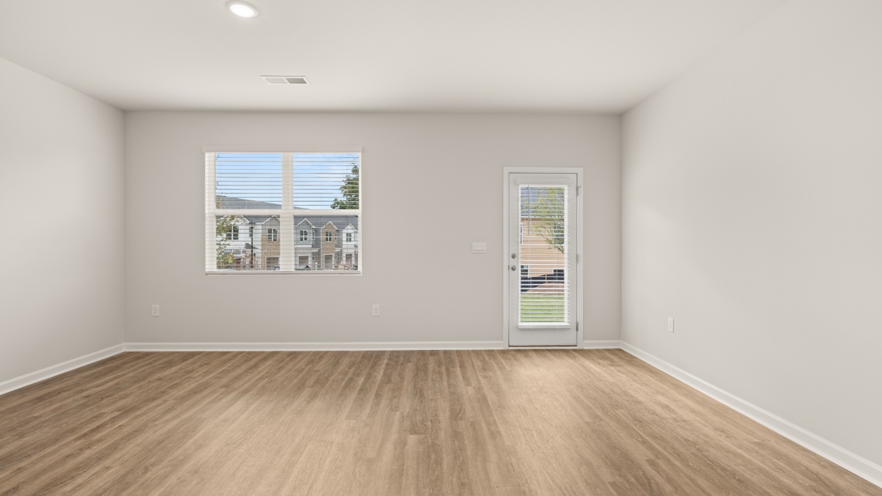 breakfast room and living room with natural light and rear patio access