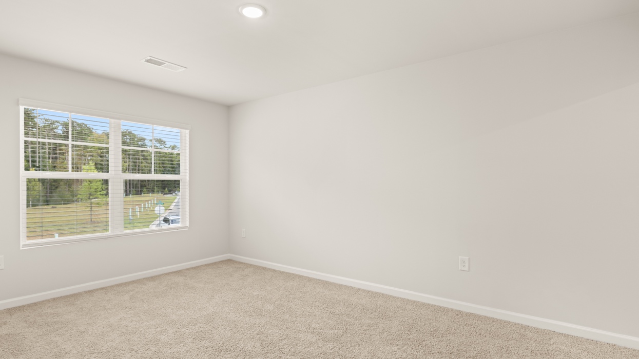 angled primary bedroom with natural light