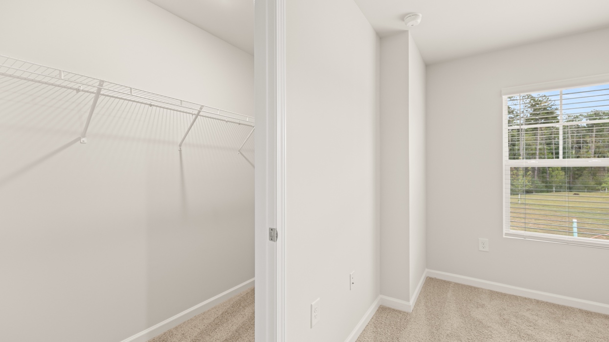 angled primary bedroom walk-in closet