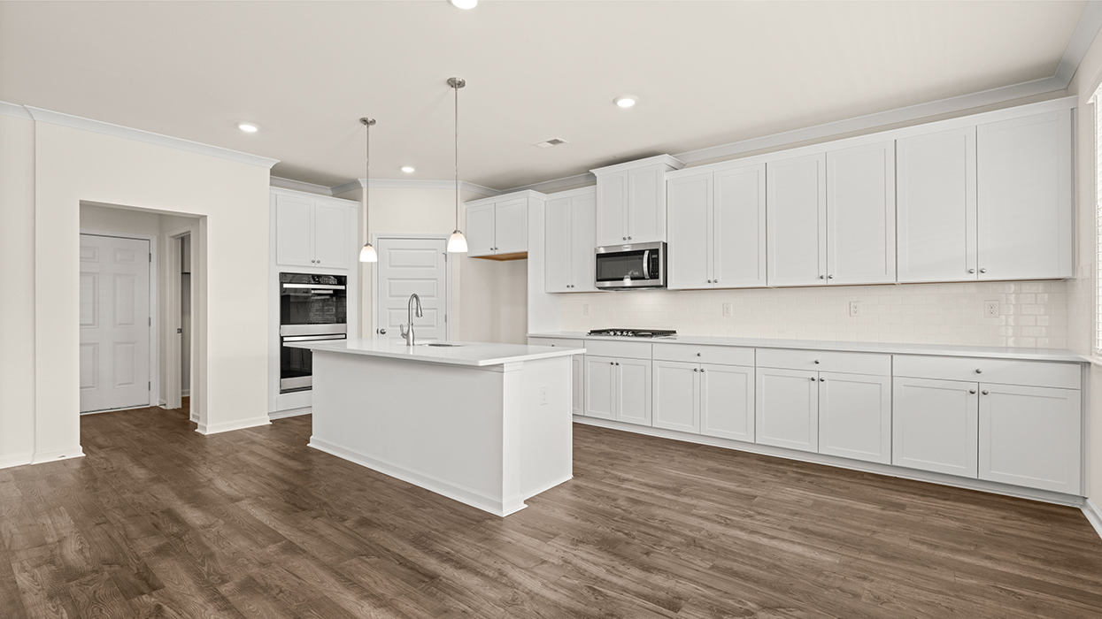 angled kitchen with spacious white cabinetry and large center island