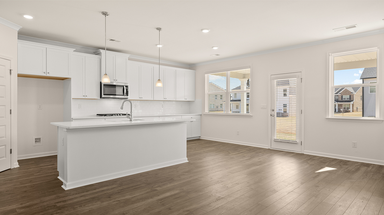 angled kitchen and breakfast room with abundance of natural light and access to rear patio
