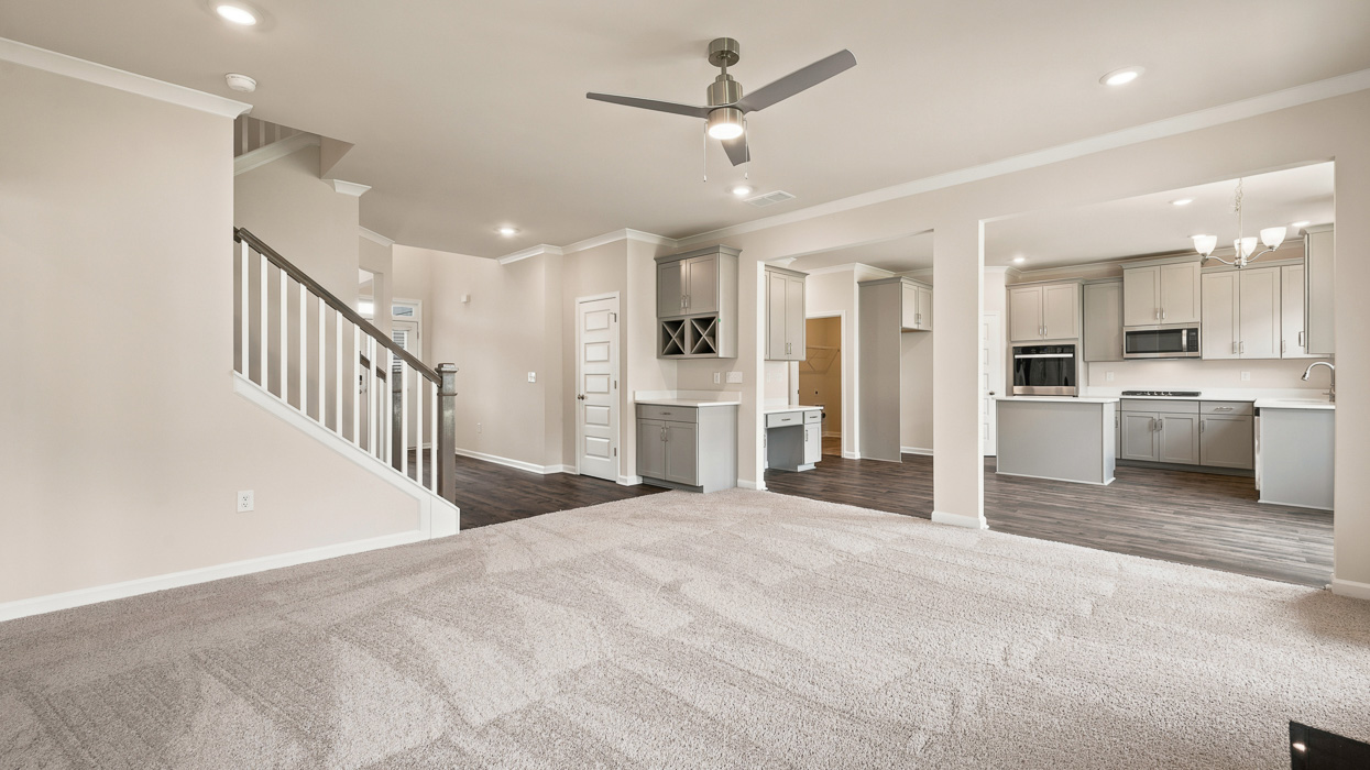 Great Room with carpet and ceiling fan