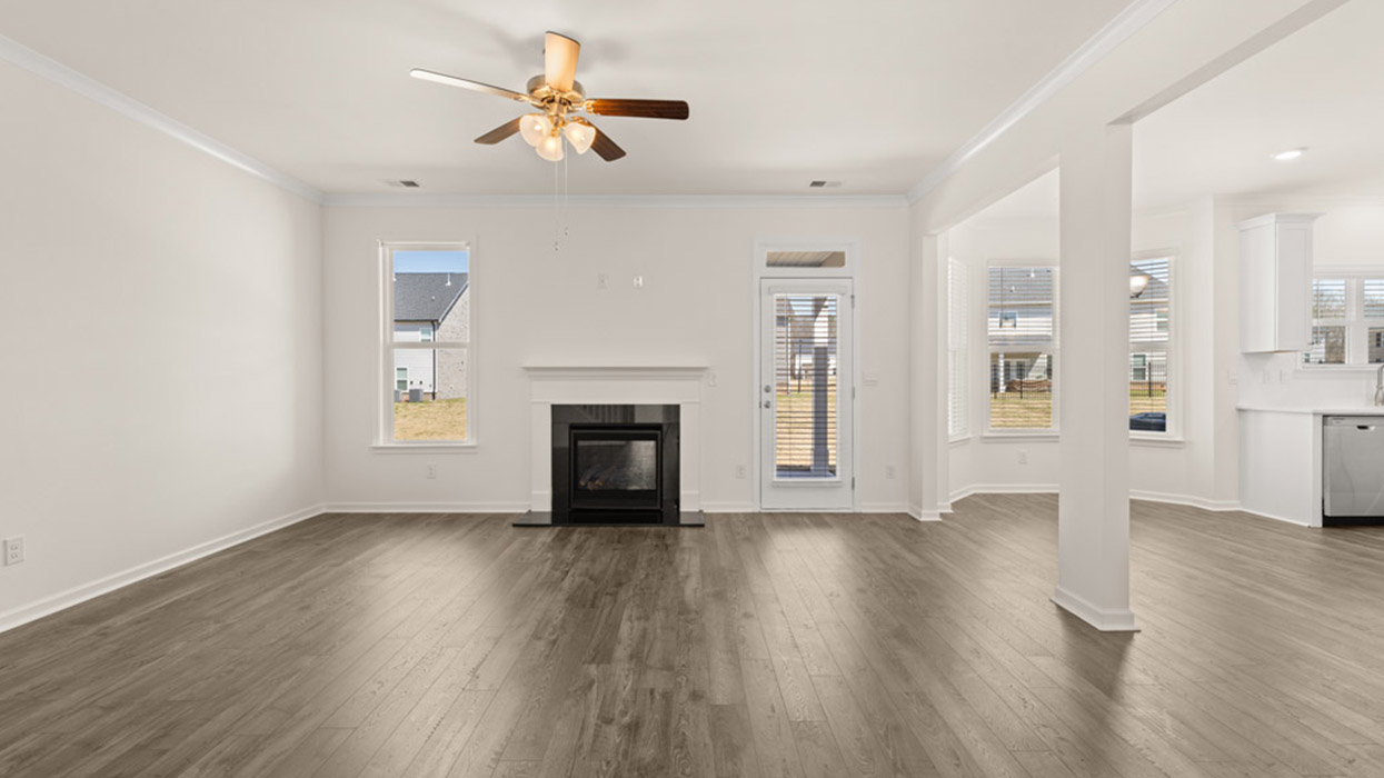 living room with ceiling fan and natural light with patio access