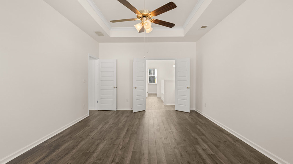 primary bedroom with ceiling fan