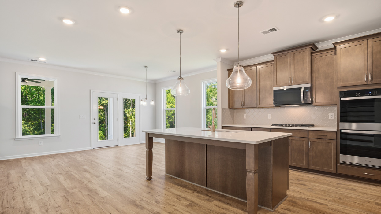 angled kitchen with large center island and spacious burlap cabinetry