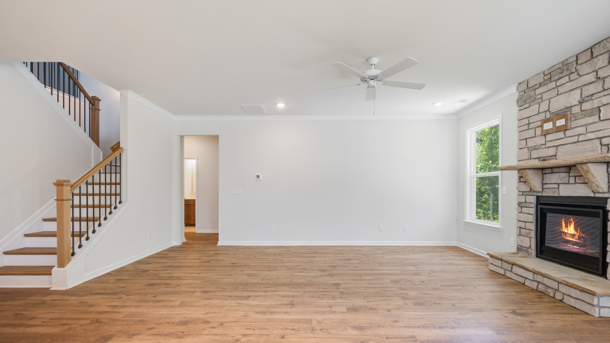 living room with ceiling fan and natural light