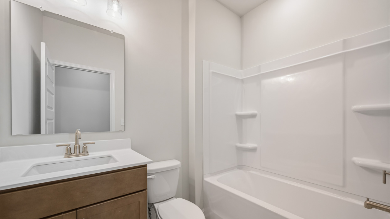 bathroom with single sink and tub