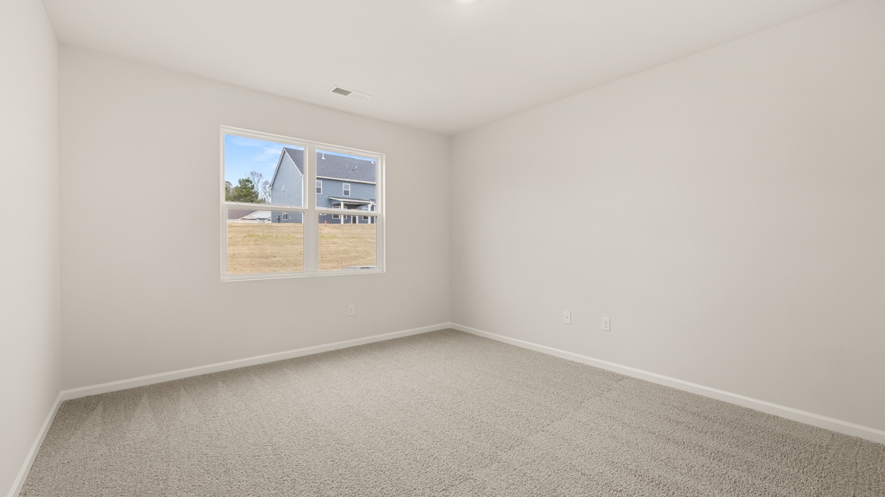 angled primary bedroom with natural light