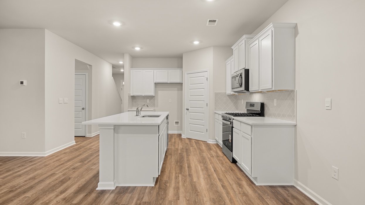 kitchen with spacious white cabinetry and large center island