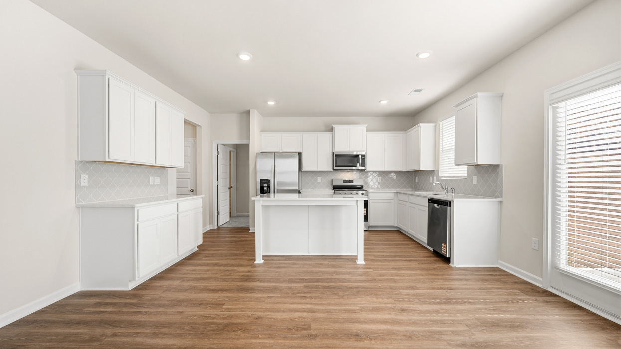 kitchen with large center island and spacious white cabinetry